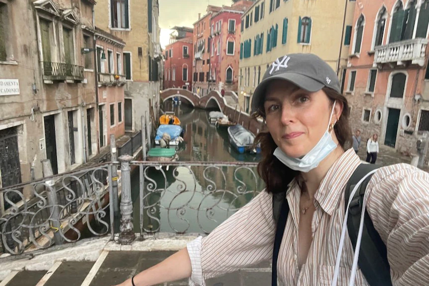 Sybella Stevens takes a selfie on a bridge overlooking the canal in Venice.  