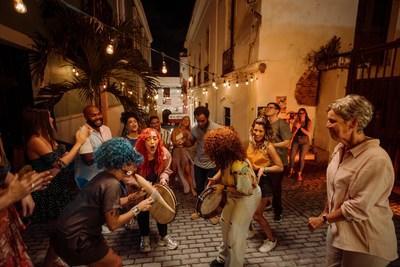 Discover Puerto Rico unveils “Live Boricua” brand campaign. Pictured is a campaign snapshot of Boricuas dancing and playing el guiro and panderetas on the historical streets of Old San Juan, Puerto Rico (Credit: Discover Puerto Rico)