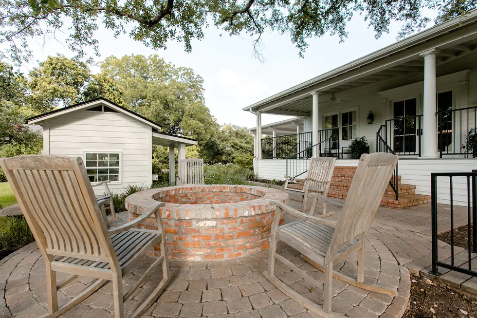 The porch, fire pit, and kitchenette in the backyard of the Hillcrest Estate.