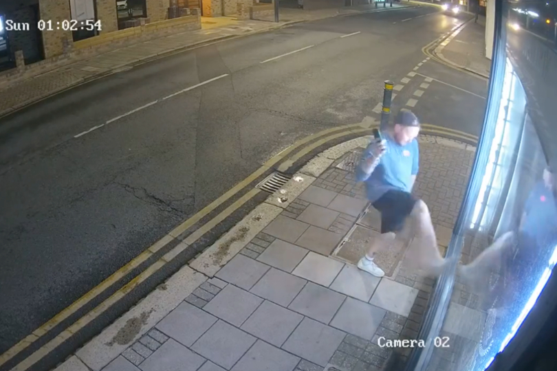 Moment man kicks in agency's door caught on camera