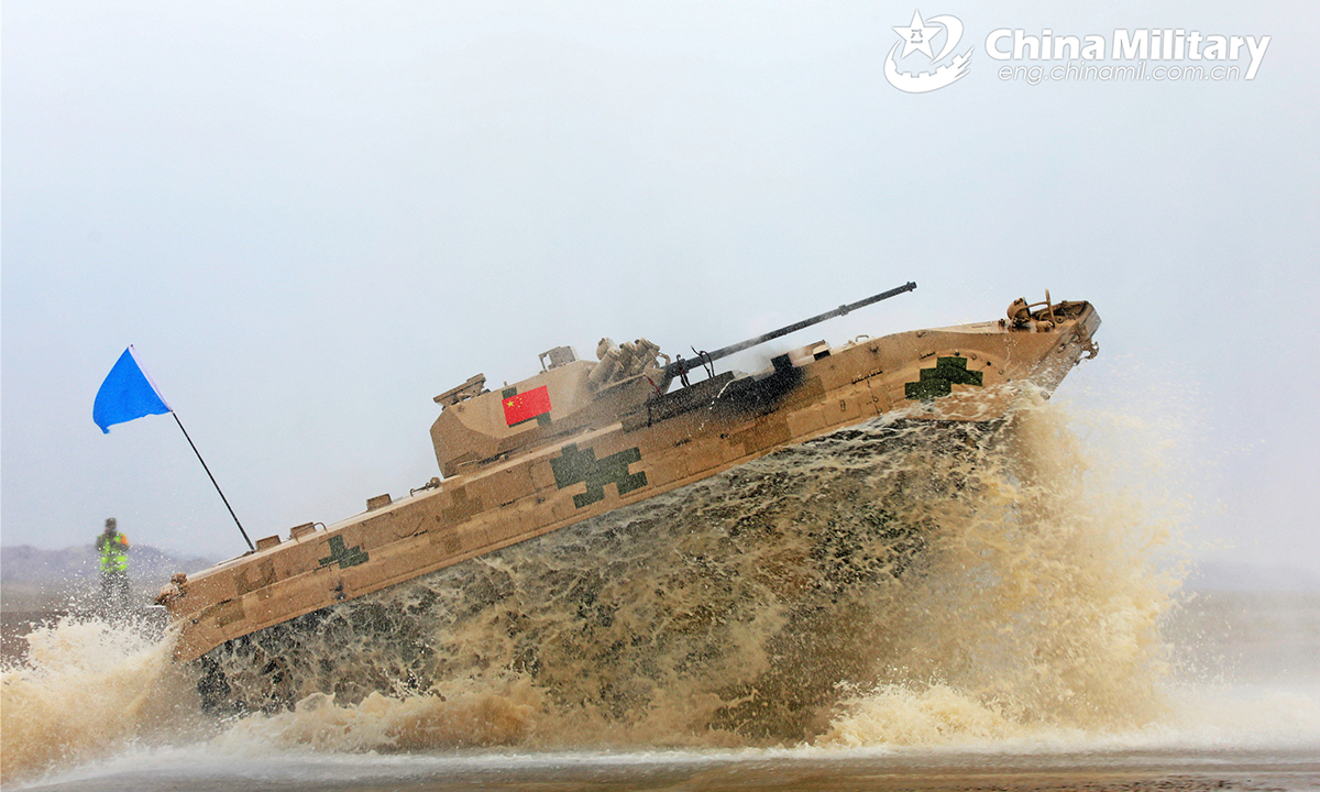 An infantry fighting vehicle of the Chinese team wades through a water ford during the second round of individual race of the Suvorov Onslaught contest in Korla, China's Xinjiang Uygur Autonomous Region, on August 16, 2022. The Suvorov Onslaught contest of the International Army Games 2022 (IAG 2022) kicked off on August 14 with participation of six teams from five countries, namely China, Russia, Belarus, Iran and Venezuela. (Photo by Luo Xingcang)