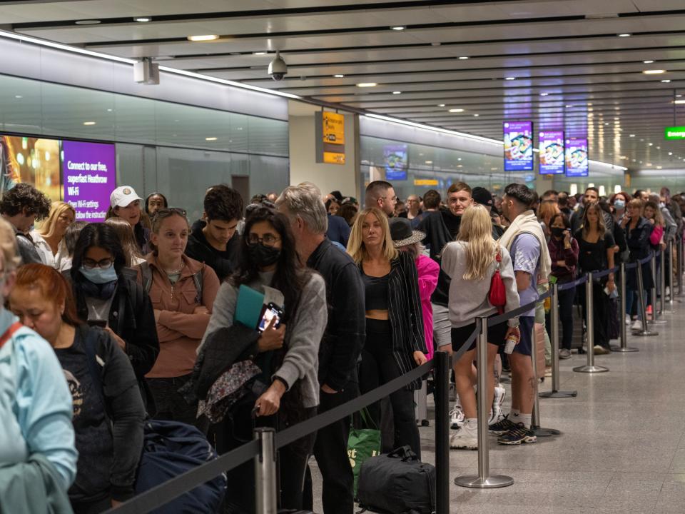 People wait in long queues for security at Heathrow Airport on June 1.