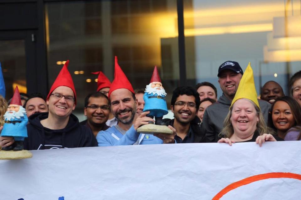 Former Expedia Group CEO Dara Khosrowshahi held aloft Travelocity mascot the Roaming Gnome when Expedia Group acquired Travelocity in 2015. Should Expedia Group keep Travelocity? Expedia Inc.