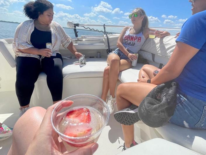 the writer and friends with cups of prosecco on a boat