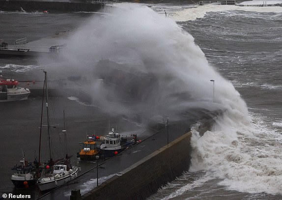Waves crash over the harbour wall as storm Babet approaches Stonehaven, Scotland, Britain October 19, 2023. REUTERS/Russell Cheyne