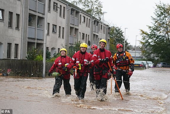 Emergency service workers walk through flood water in Brechin, Scotland, as Storm Babet batters the country. Flood warnings are in place in Scotland, as well as parts of northern England and the Midlands. Thousands were left without power and facing flooding from "unprecedented" amounts of rain in east Scotland, while Babet is set to spread into northern and eastern England on Friday. Picture date: Friday October 20, 2023. PA Photo. See PA story WEATHER Babet. Photo credit should read: Andrew Milligan/PA Wire