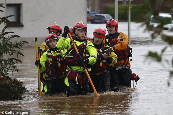 BRECHIN,SCOTLAND - OCTOBER 20: Members of a rescue team wade through the flood waters on October 20, 2023 in Brechin Scotland. Areas close to the river have been overwhelmed by water which breached the flood defences in the early hours of this morning. Rare Red weather warnings are in place in Scotland and amber warnings in the north of England until Saturday as Storm Babet sweeps the country. (Photo by Jeff J Mitchell/Getty Images)