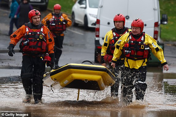 BRECHIN,SCOTLAND - OCTOBER 20: Members of a rescue team make their way through the flood waters on October 20, 2023 in Brechin Scotland. Areas close to the river have been overwhelmed by water which breached the flood defences in the early hours of this morning. Rare Red weather warnings are in place in Scotland and amber warnings in the north of England until Saturday as Storm Babet sweeps the country. (Photo by Jeff J Mitchell/Getty Images)