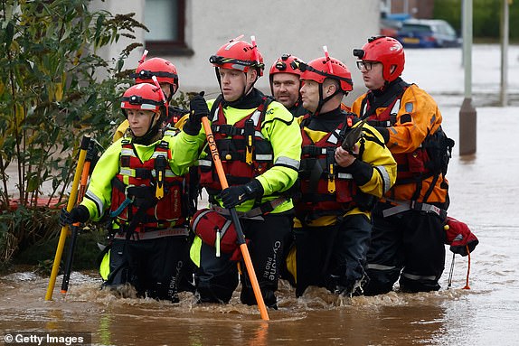 BRECHIN,SCOTLAND - OCTOBER 20: Members of a rescue team wade through the flood waters on October 20, 2023 in Brechin Scotland. Areas close to the river have been overwhelmed by water which breached the flood defences in the early hours of this morning. Rare Red weather warnings are in place in Scotland and amber warnings in the north of England until Saturday as Storm Babet sweeps the country. (Photo by Jeff J Mitchell/Getty Images)