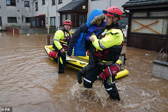 BRECHINAutumn weather October 20th 2023A member of the emergency services carries a boy from a house in Brechin, Scotland, as Storm Babet batters the country. Flood warnings are in place in Scotland, as well as parts of northern England and the Midlands. Thousands were left without power and facing flooding from "unprecedented" amounts of rain in east Scotland, while Babet is set to spread into northern and eastern England on Friday. Picture date: Friday October 20, 2023.