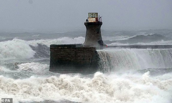 Waves crash against South Shields lighthouse after the top was ripped off as Storm Babet batters the country. Flood warnings are in place in Scotland, as well as parts of northern England and the Midlands. Thousands were left without power and facing flooding from "unprecedented" amounts of rain in east Scotland, while Babet is set to spread into northern and eastern England on Friday. Picture date: Friday October 20, 2023. PA Photo. See PA story WEATHER Babet. Photo credit should read: Owen Humphreys/PA Wire