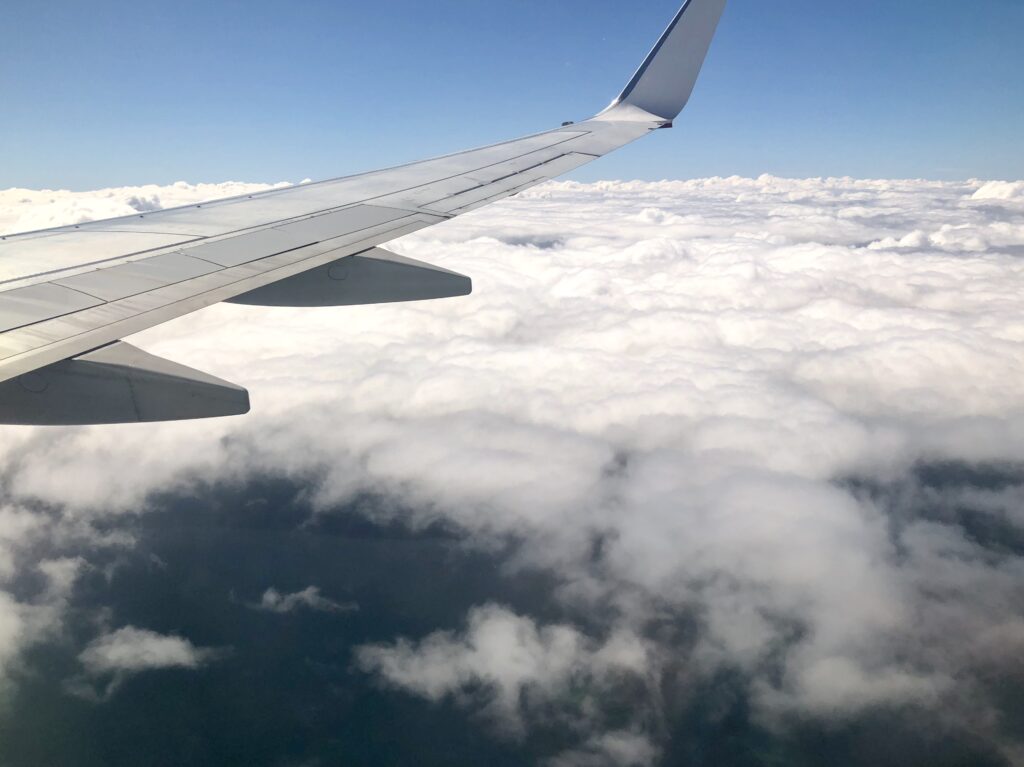 Cabin window view of clouds aircraft wing over Queensland - Travel News, Insights & Resources.