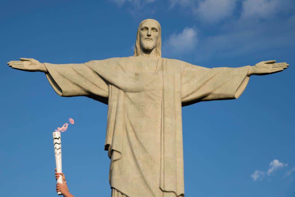 The statue, shown here with the Olympic torch in 2016, presides over one of the most crime-ridden capitals in the world. Source: AAP