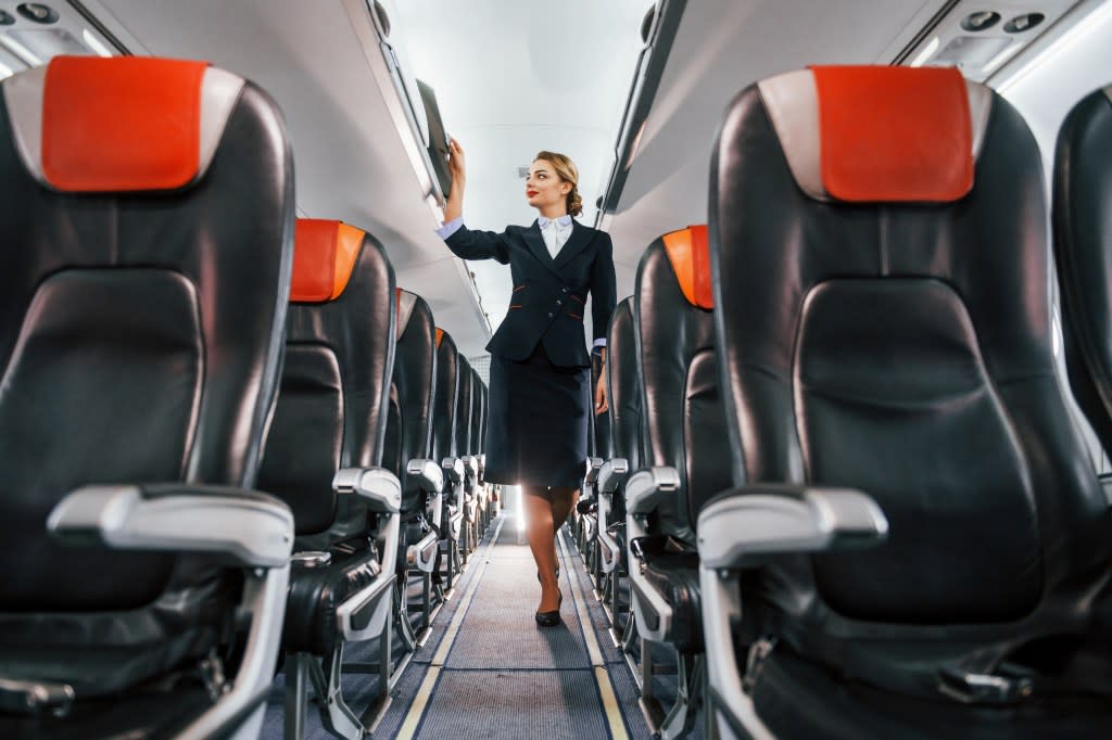 If a passenger notices an empty seat, they should ask the flight attendant if they can switch. standret – stock.adobe.com