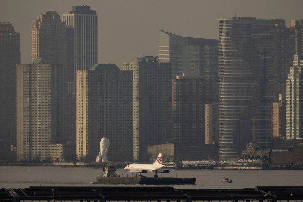 A retired British Airways Concorde supersonic aircraft is transported by barge on the Hudson River, Thursday, March 14, 2024, in New York. (AP Photo/Yuki Iwamura)