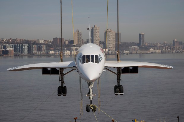 A retired British Airways Concorde supersonic aircraft is lifted by a crane at the Intrepid Museum, Thursday, March 14, 2024, in New York. (AP Photo/Yuki Iwamura)