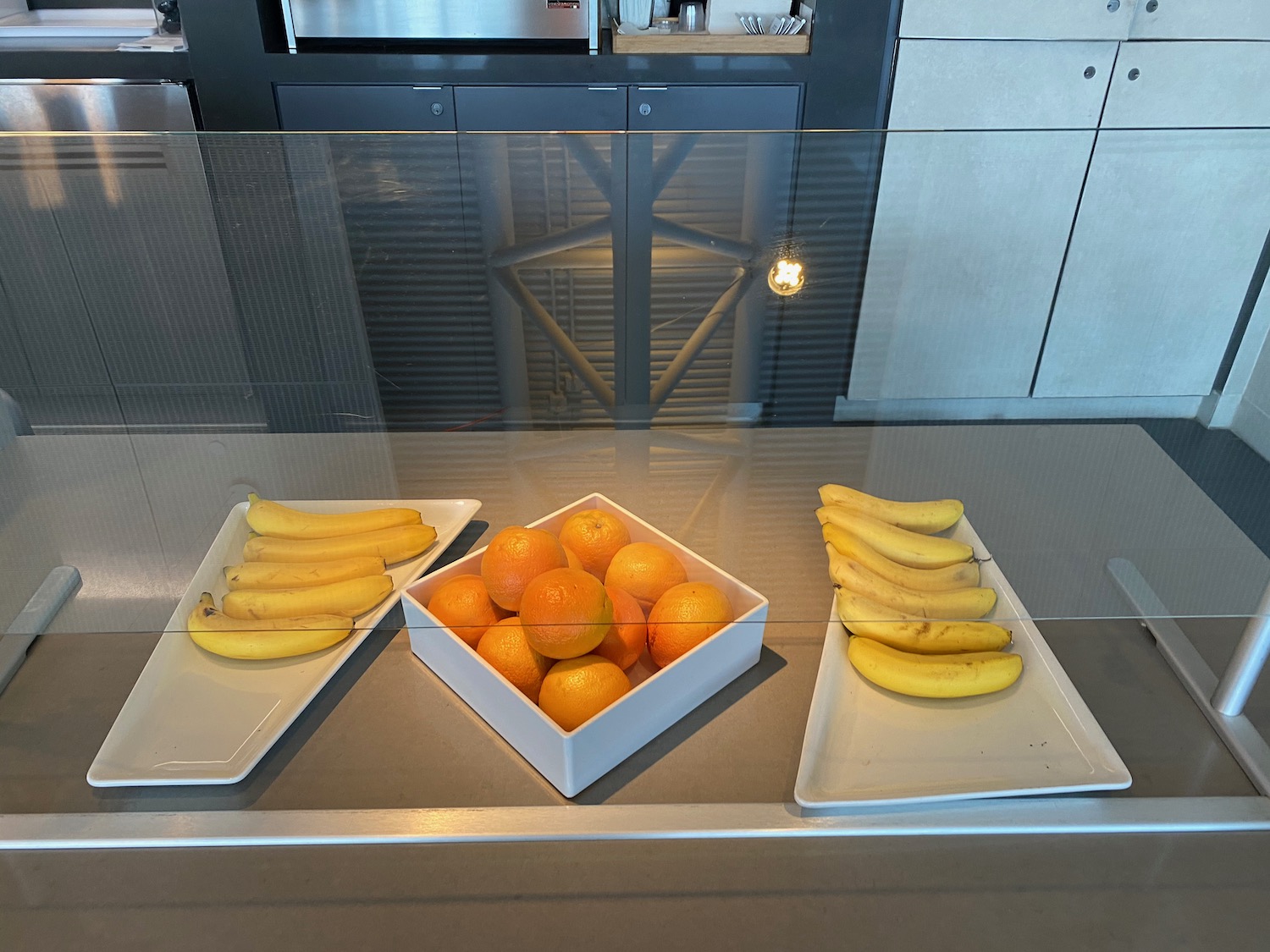 a group of bananas and oranges on plates