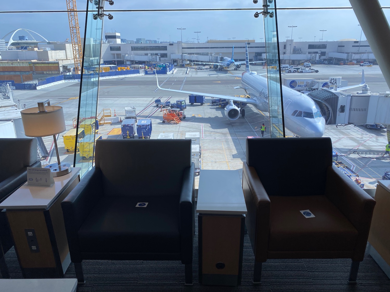 two chairs and a plane in an airport