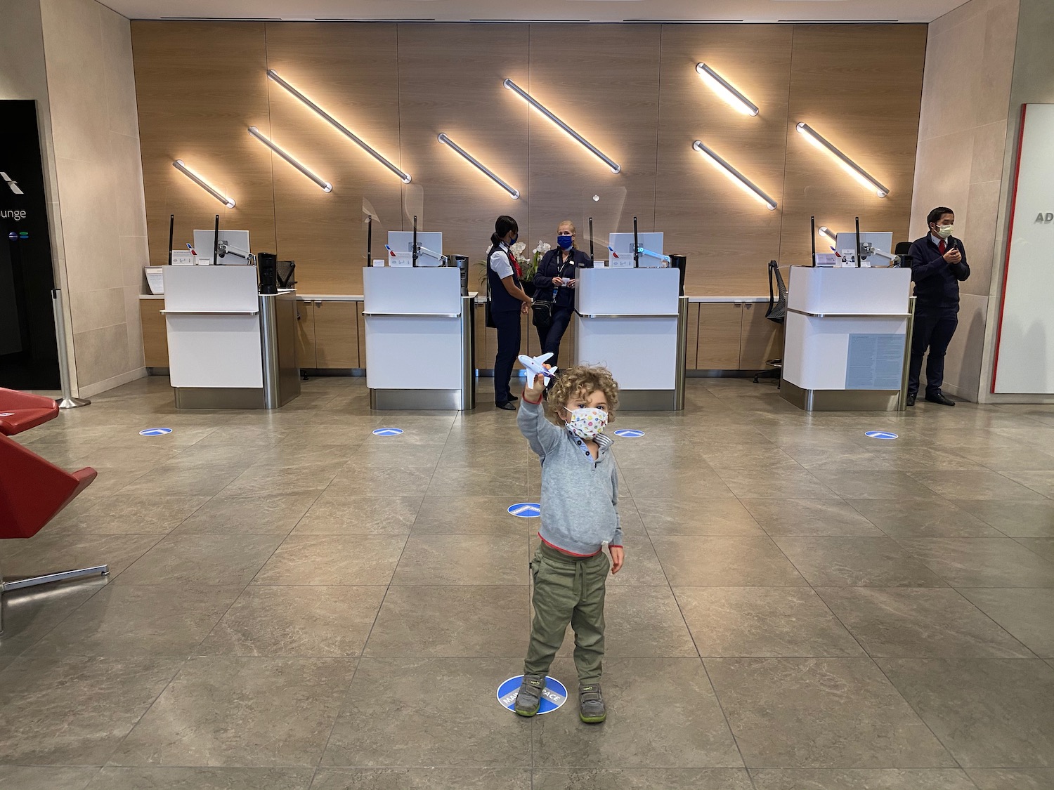 a child wearing a mask in front of a counter