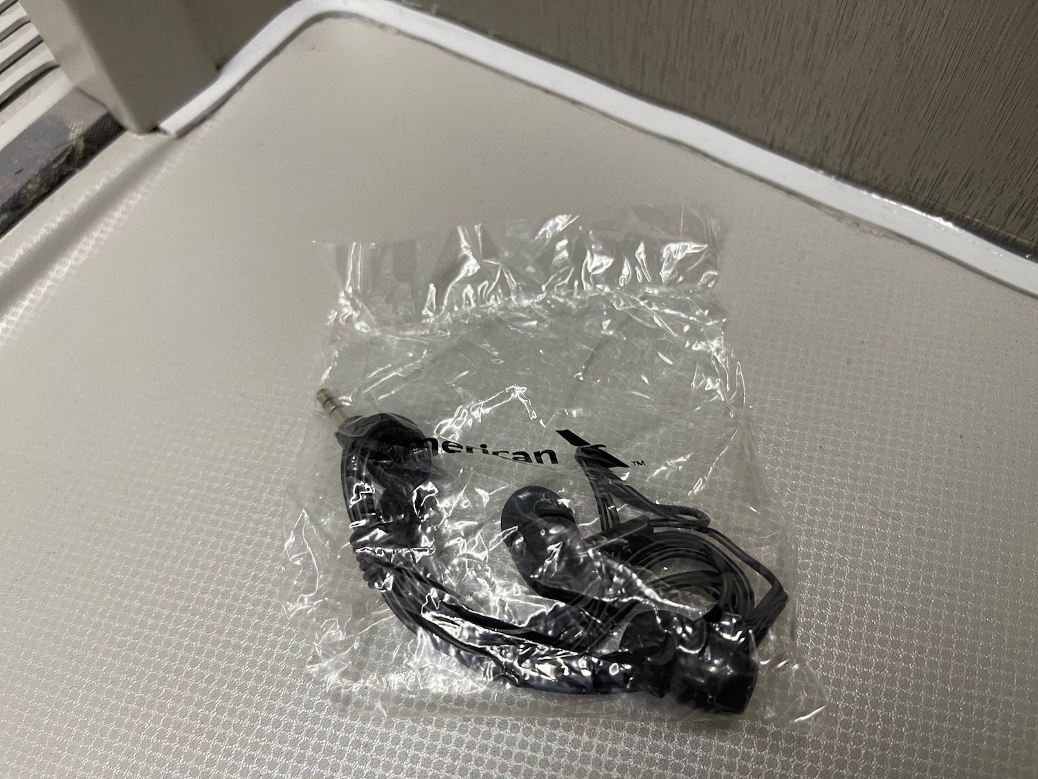 a black earbuds in a plastic bag