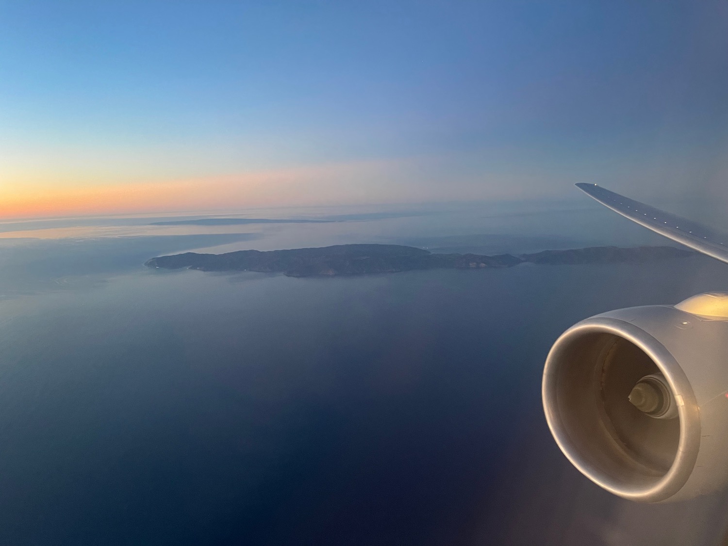 an airplane wing and a body of water
