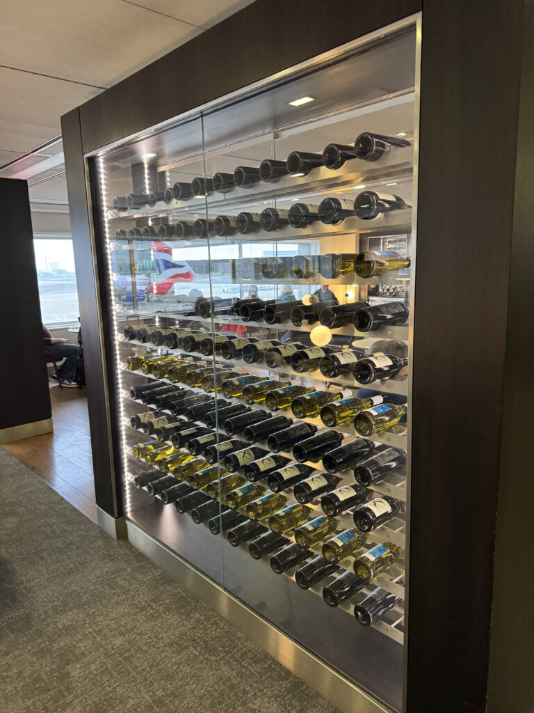 A large glass display case holding many bottles of wine. 