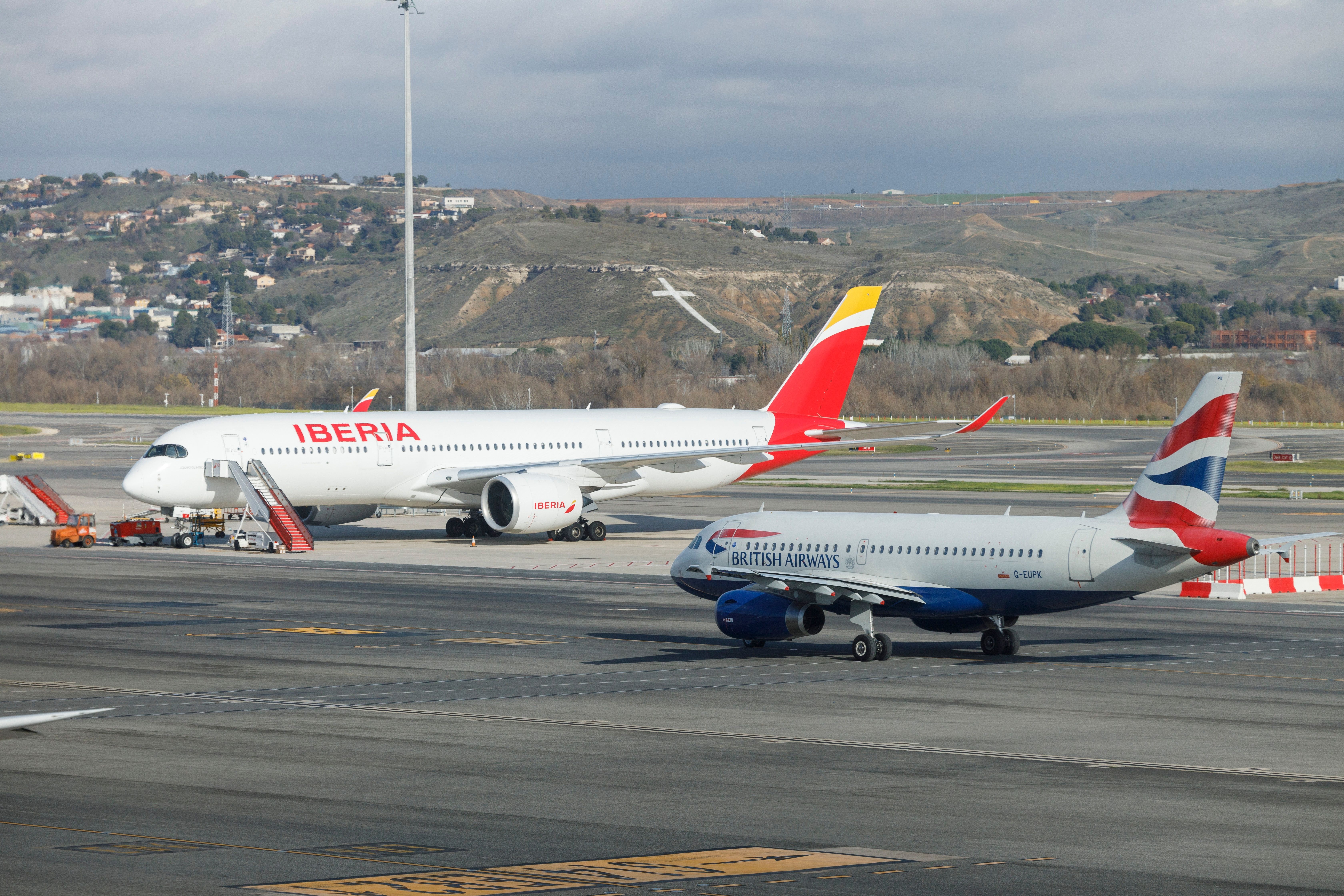 British Airways and Iberia aircraft at Madrid Bajaras Airport MAD shutterstock_2241188177