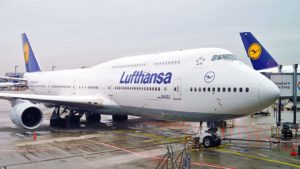a Lufthansa plane docked at an airport