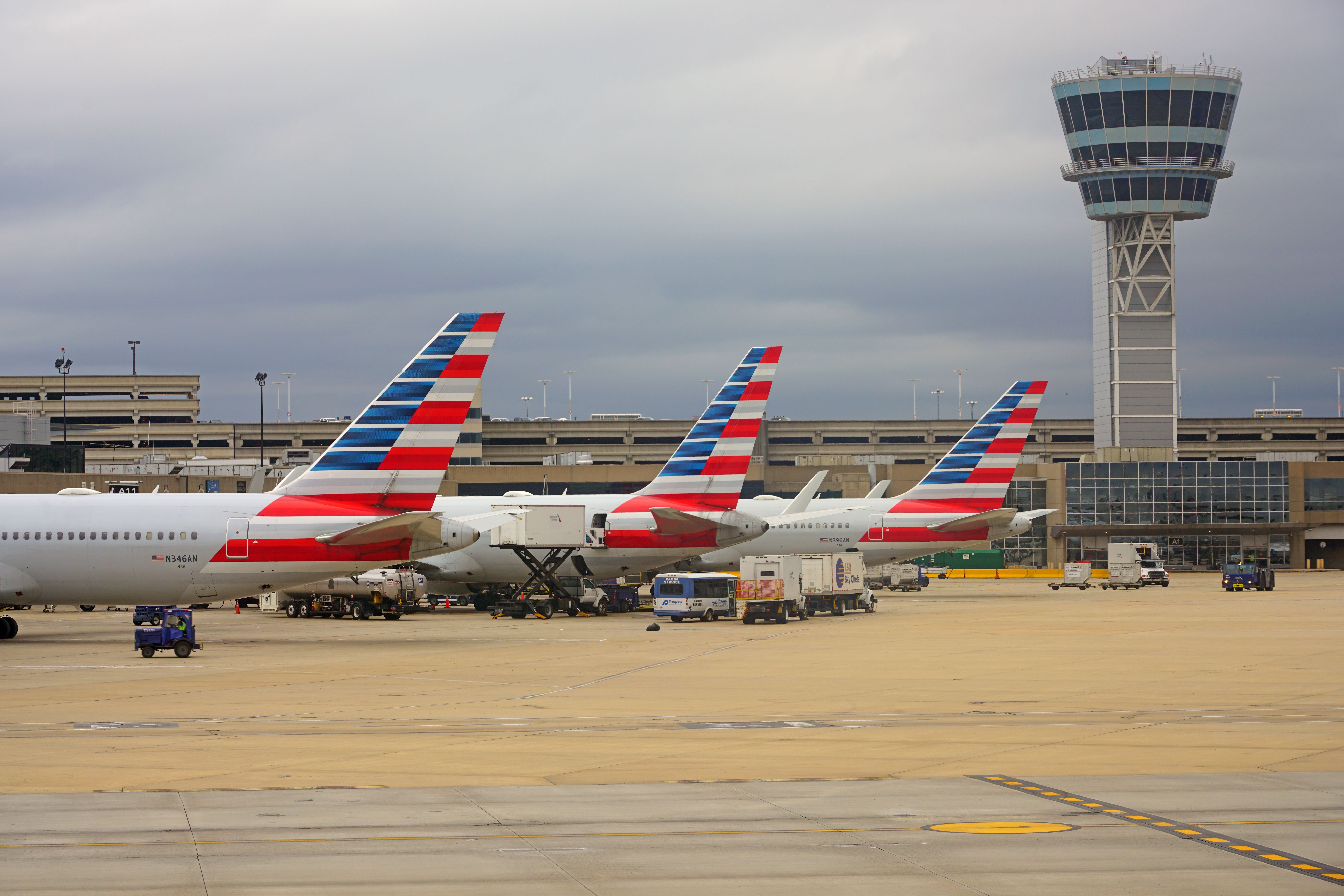 Three American Airlines aircraft parked side by side on an airport apron.