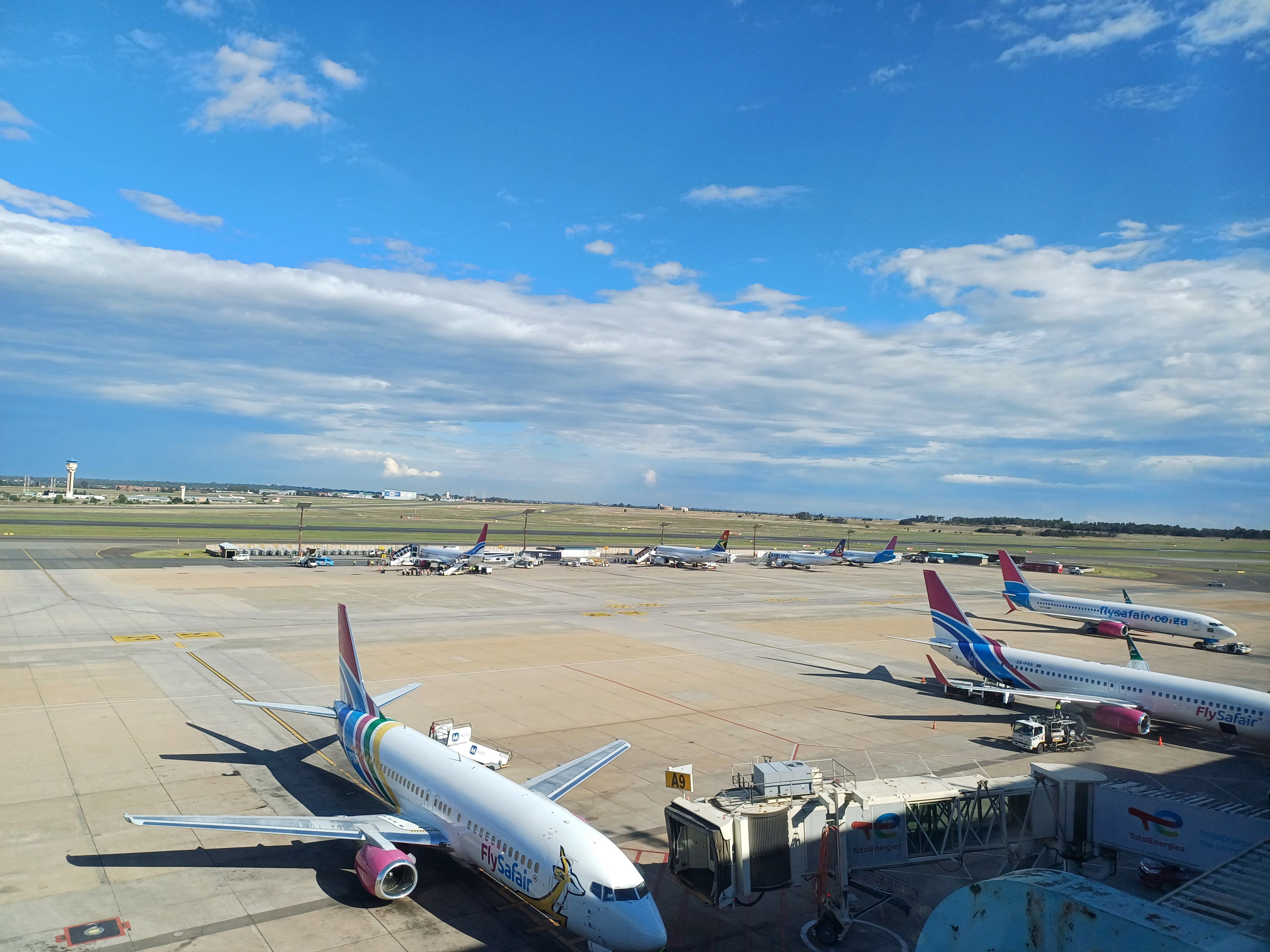 Multiple FlySafair Boeing 737s on the apron at OR Tambo Airport.