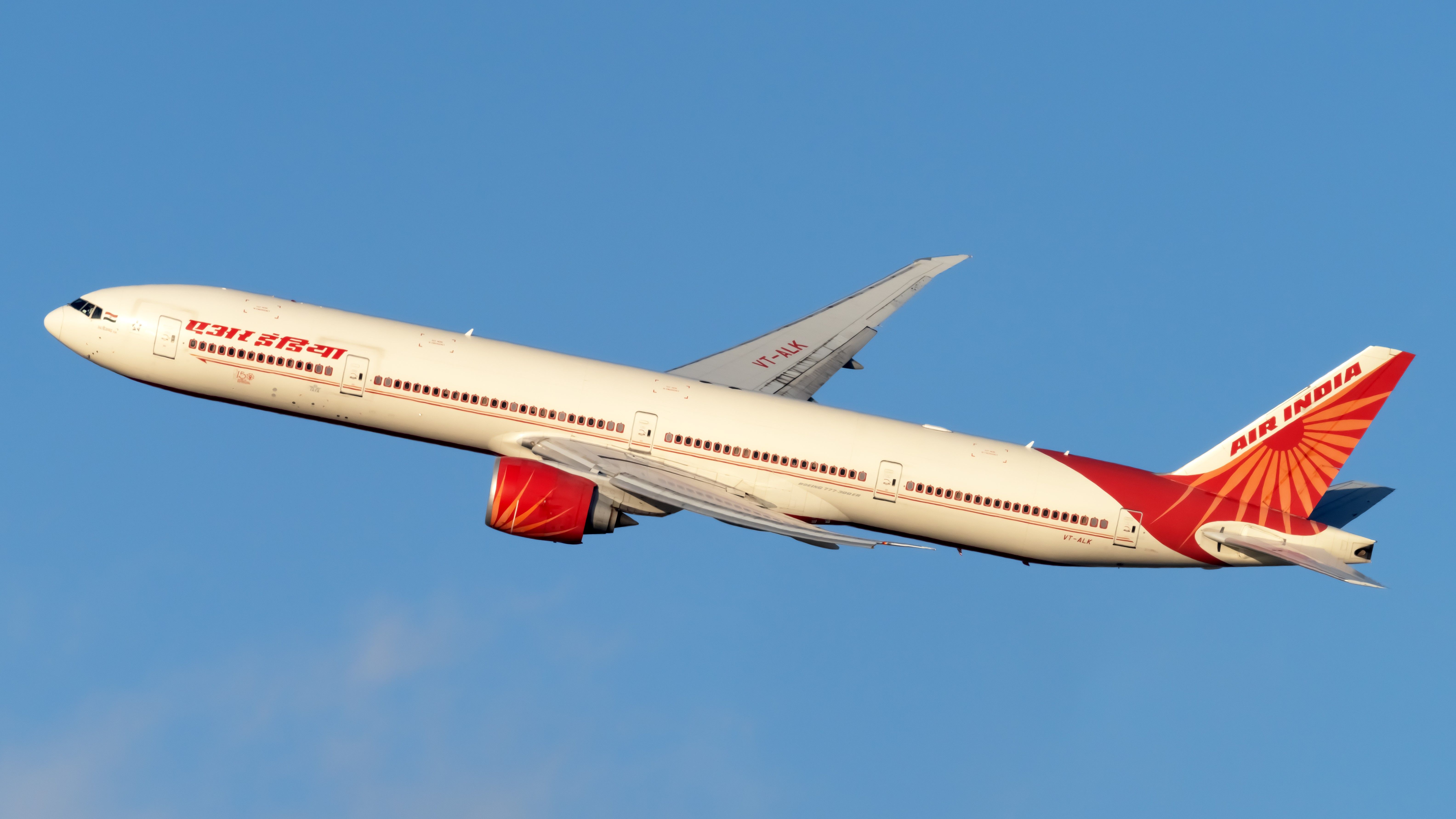 An Air India Boeing 777-300 flying in the sky.