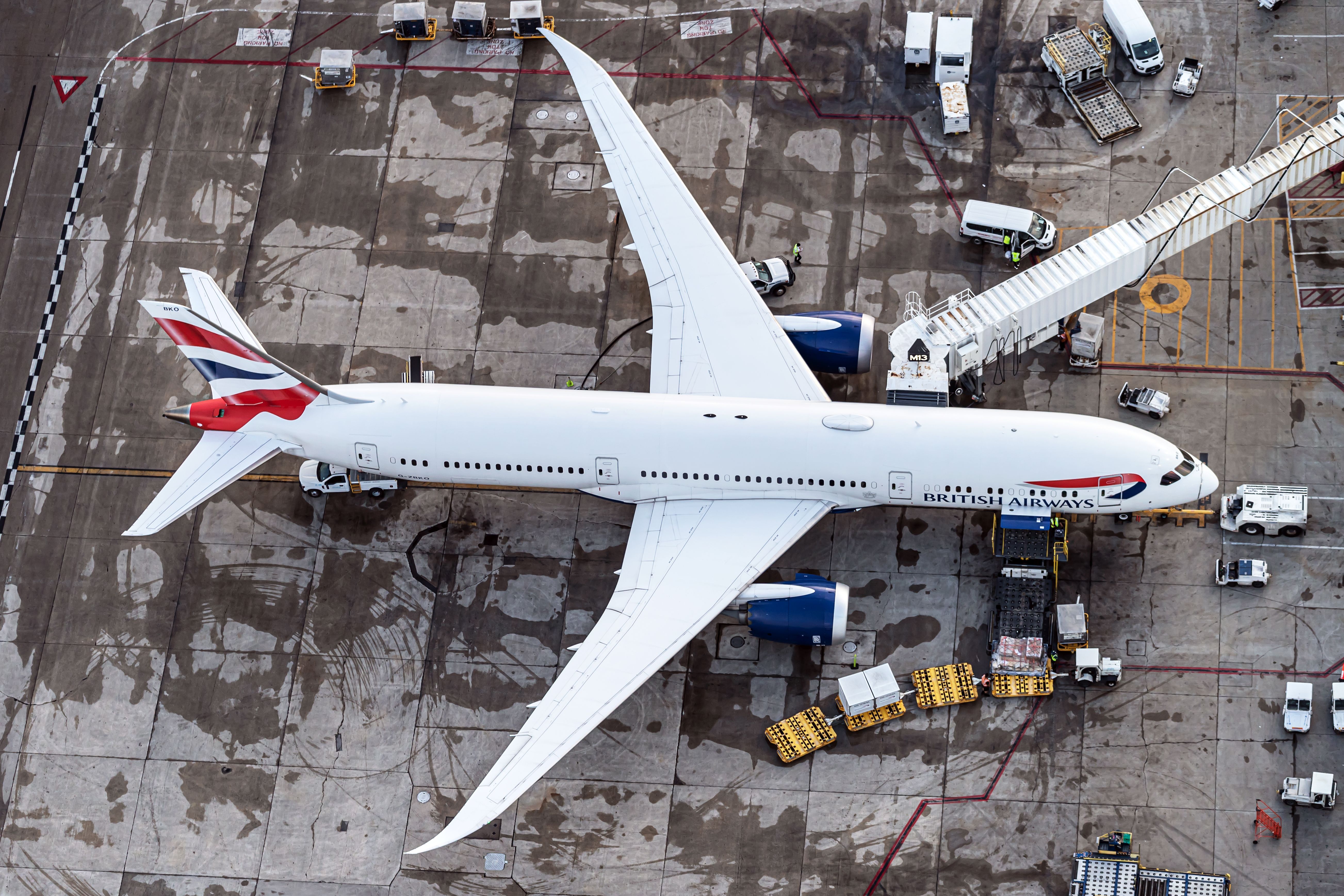 A British Airways Boeing 787 Dreamliner 9 can be seen from above, from a helicopter perspective. The plane is parked.