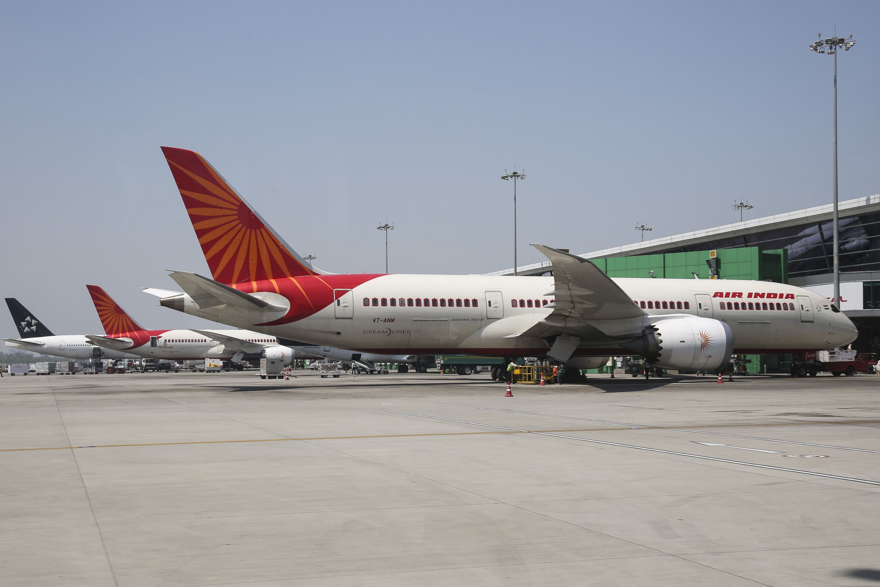 Several Air India aircraft parked on an airport apron.
